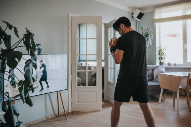 istock Japanese man taking online boxing lessons during lockdown in isolation 1217191825