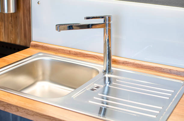 istock New faucet and stainless steel sink. Modern comfortable kitchen. 1217193878