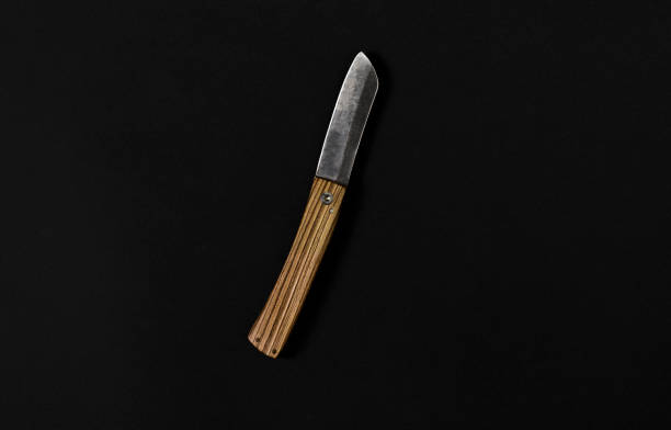 istock Knife with wooden handle on black background. 1217194630