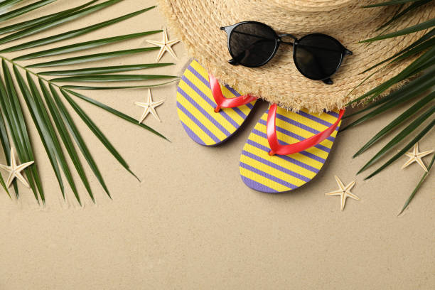 istock Summer vacation accessories on sea sand background, space for text 1217195428
