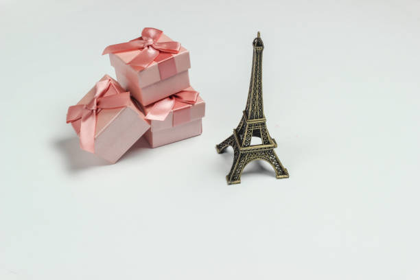 istock gift boxes with bows and a statuette of the Eiffel Tower on a white background. Shopping in Paris, souvenirs 1217195671