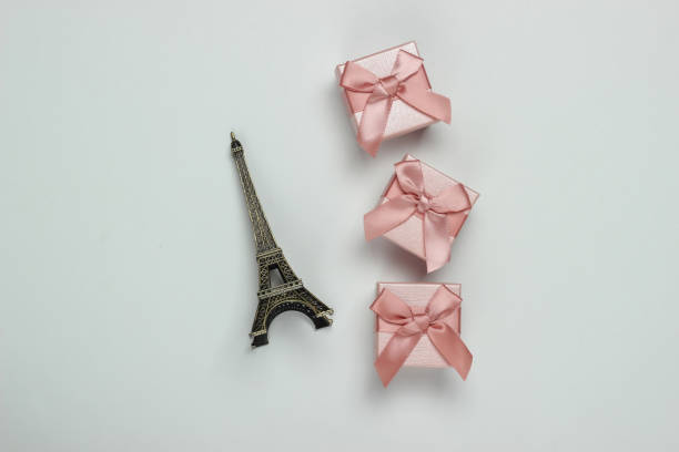 istock gift boxes with bows and a statuette of the Eiffel Tower on a white background. Shopping in Paris, souvenirs 1217195798