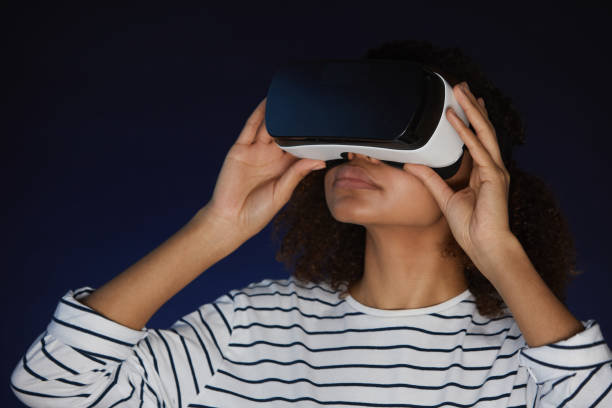istock Young Woman Wearing VR Helmet 1217196151