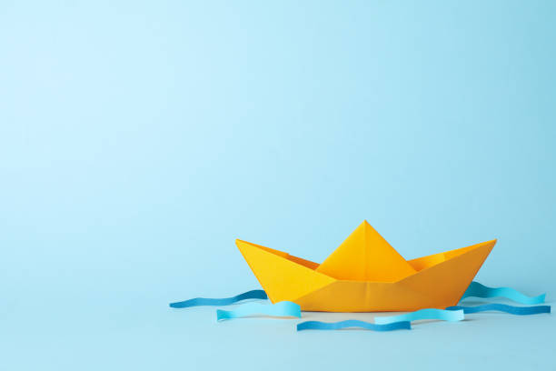 istock Paper boat and waves on blue background, space for text 1217196964