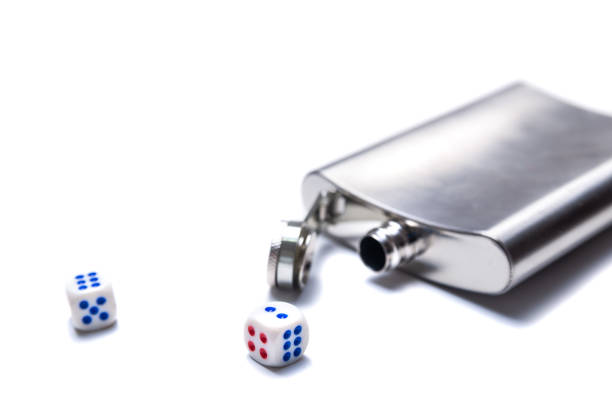 istock Dice and open metal flask for alcohol on a white background 1217199348