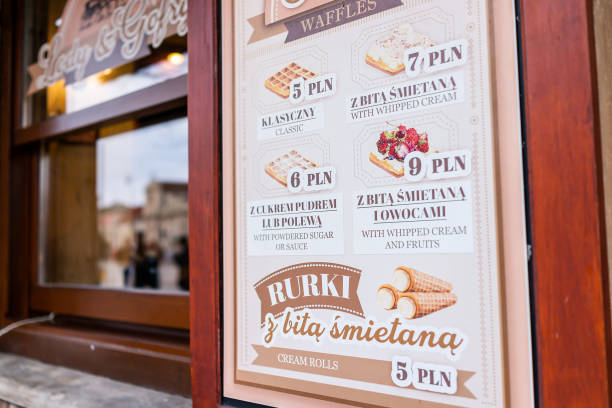 Old town historic street in capital city Krakowskie Przedmiescie sign for dessert cafe Warsaw, Poland - December 25, 2019: Old town historic street in capital city Krakowskie Przedmiescie winter day and sign for dessert cafe menu by window for cheap waffles and rurki 18797 stock pictures, royalty-free photos & images