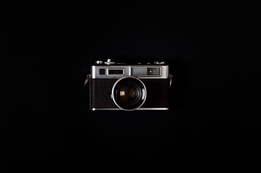 Old style camera on a black background.