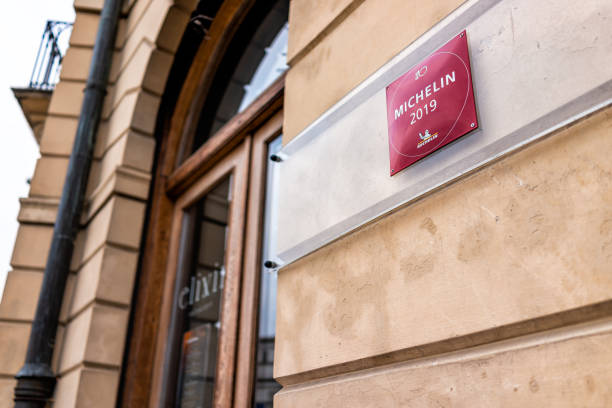 Capital city with sign closeup for Michelin star at Elixir restaurant by Dom Wodki Warsaw, Poland - December 25, 2019: Old town capital city with sign closeup for Michelin star at Elixir restaurant by Dom Wodki book title stock pictures, royalty-free photos & images