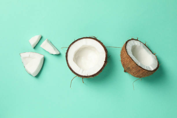 istock Flat lay with coconut on mint background. Tropical fruit 1217199780