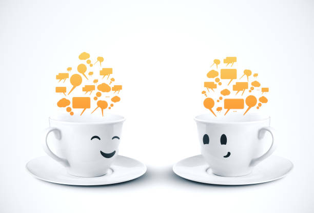 Two coffee cup smiling with color speech bubbles stock photo
