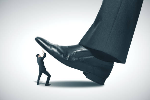 istock Big foot stepping on businessman. 1217200855