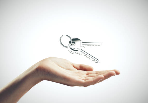 istock Hand holding key to new house 1217200864
