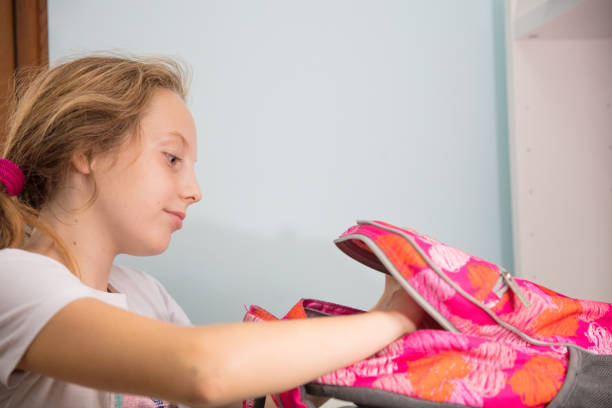 istock Schoolgirl packing 1217201373