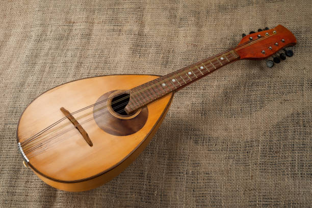 Close up of hands playing a vintage mandolin