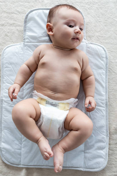 istock Happy baby looking to the side while lying on the bed at home. 1217202818