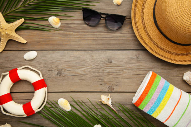 istock Beach accessories with palm leaves on grey wooden background 1217204030