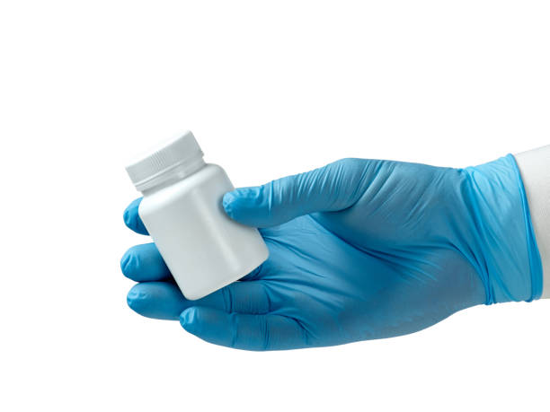 istock hand in a blue glove holding a white plastic jar 1217204693