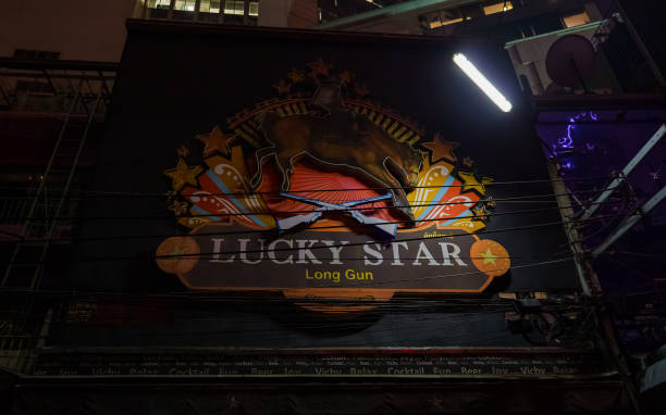 Bangkok, Thailand - April 2, 2020: Bangkok's infamous Soi Cowboy red-light district lies in darkness, its go-go bars and neon signs shut down as Thailand imposes a national night-time curfew to arrest the spread of the coronavirus pandemic and the Covid-19 pulmonary disease it causes.