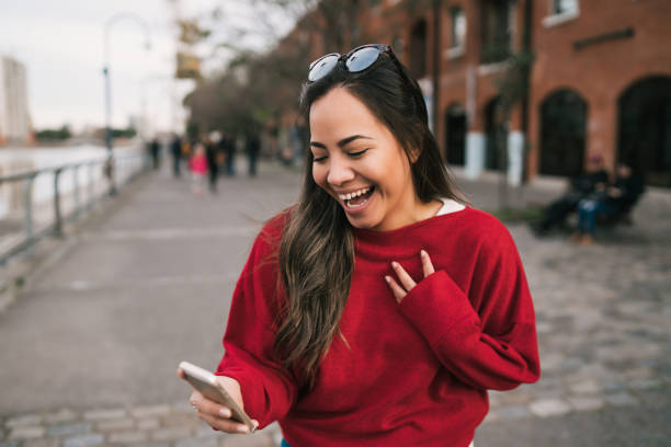 istock Woman holding phone with successful expression. 1217207271