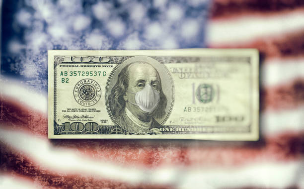 istock 100 Dollar Bill with mouthguard for COVID-19 Corona Virus 1217207809