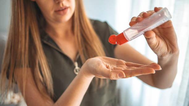 istock A Hand apply alcohol gel from clear plastic bottle to another hand 1217208017