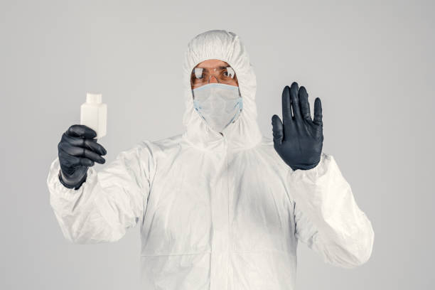 istock A man in a medical protective mask, holding a hand sanitizer. 1217209367