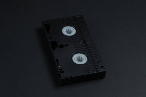 istock Video cassette on a black background. Retro storage media, videotape. 80s 1217212571