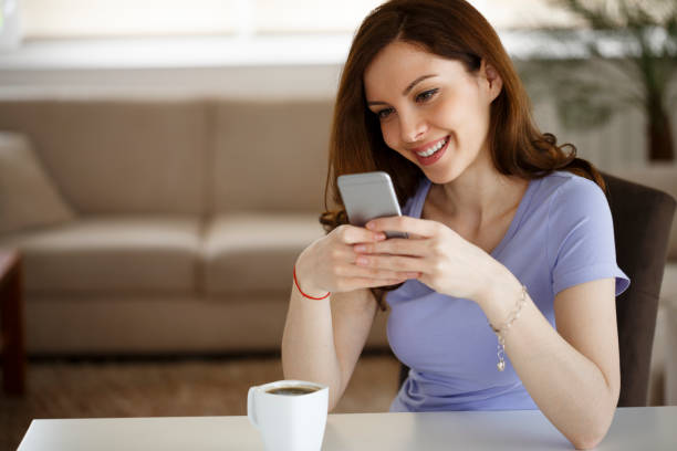 istock Young woman using mobile phone at home 1217214339