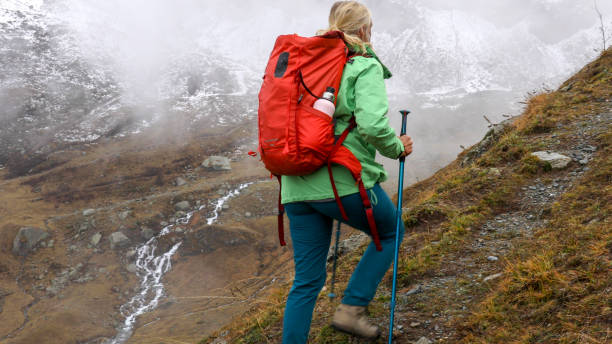 istock Mature woman hikes along mountain ridge 1217216341
