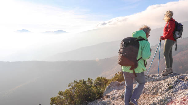 istock Hiking couple ascend mountain ridge 1217216458