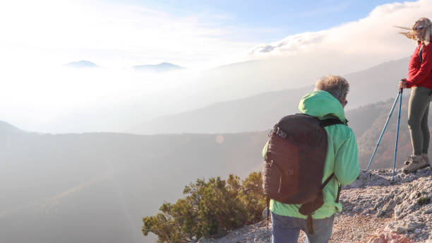 istock Hiking couple ascend mountain ridge 1217216481