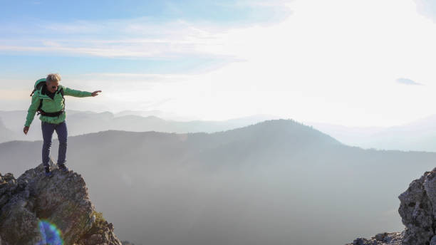 istock Male hiker ascends  mountain ridge 1217216665