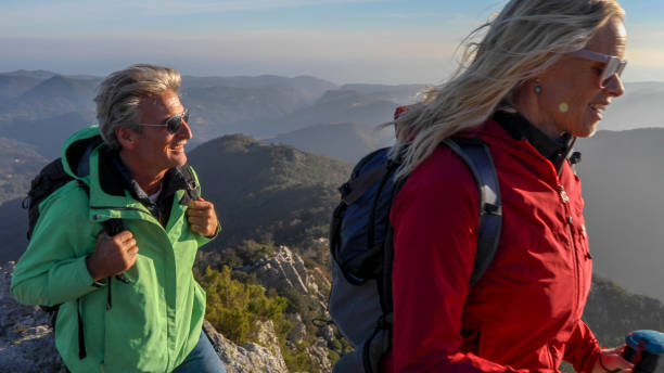 istock Hiking couple ascend mountain ridge 1217216703