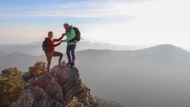 istock Hiking couple ascend mountain ridge 1217216739