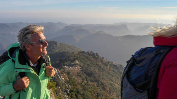 istock Hiking couple ascend mountain ridge 1217216749