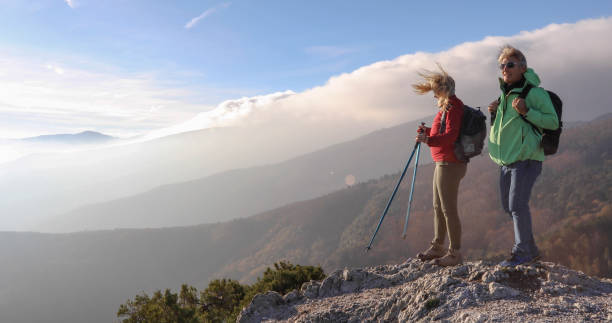 istock Hiking couple ascend mountain ridge 1217216788