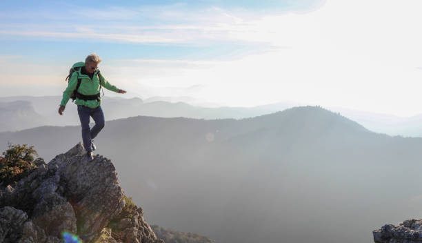 istock Male hiker ascends  mountain ridge 1217216793