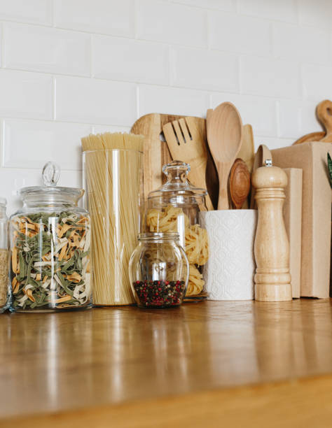 istock Various cereals and seeds in glass jars on the white textured background. Kitchen interior ideas. Eco friendly kitchen, zero waste home concept 1217217122