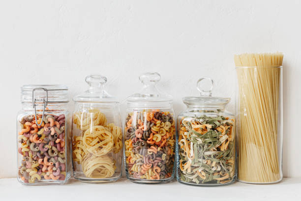 istock Various cereals and seeds in glass jars on the white textured background. Kitchen interior ideas. Eco friendly kitchen, zero waste home concept 1217217160