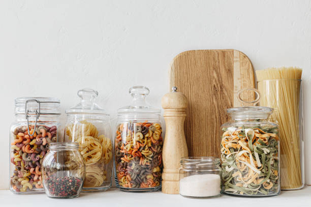 istock Various cereals and seeds in glass jars on the white textured background. Kitchen interior ideas. Eco friendly kitchen, zero waste home concept 1217217310