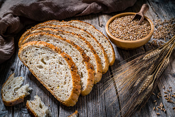 istock Healthy food: wholegrain bread with seeds and cereals on rustic kitchen table 1217217390