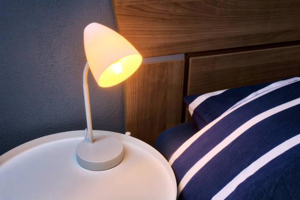 istock Modern Night Lamp next to bed retro design, lamp on night table close-up 1217218088