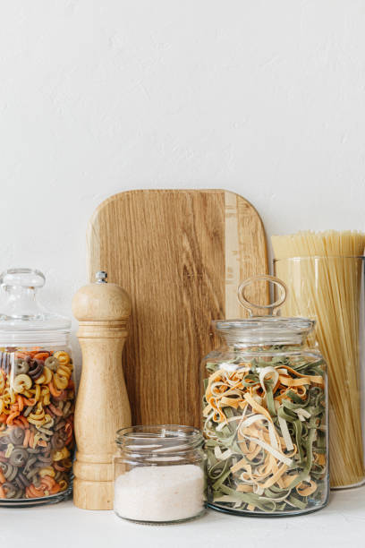 istock Various cereals and seeds in glass jars on the white textured background. Kitchen interior ideas. Eco friendly kitchen, zero waste home concept 1217218127