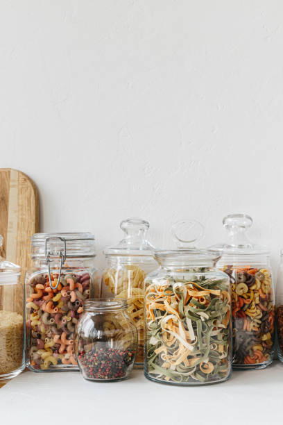 istock Various cereals and seeds in glass jars on the white textured background. Kitchen interior ideas. Eco friendly kitchen, zero waste home concept 1217218160