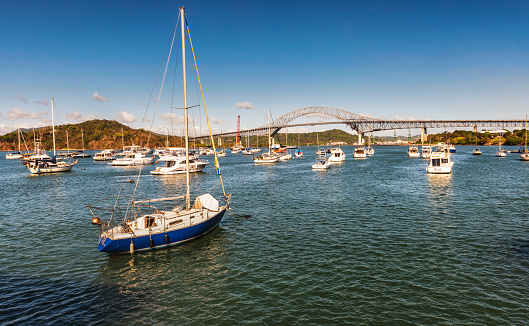 Panama city, Panama - February 20, 2017: Small boats at the bridge of Americas. It is a road bridge in the Republic of Panama that crosses the Pacific approach to the Panama canal.