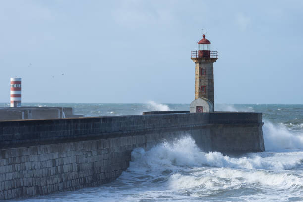 istock Waves hitting the lighthouse on a sunny day 1217218679