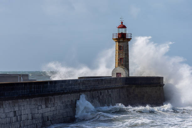istock Waves hitting the lighthouse on a sunny day 1217218694