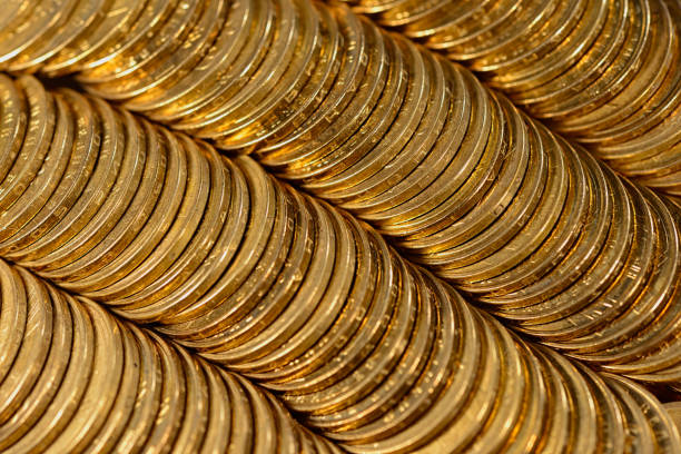 filas de monedas de oro se encuentran en la mesa. - token gold coin treasure fotografías e imágenes de stock