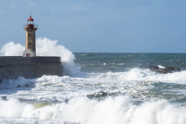istock Waves hitting the lighthouse on a sunny day 1217218711