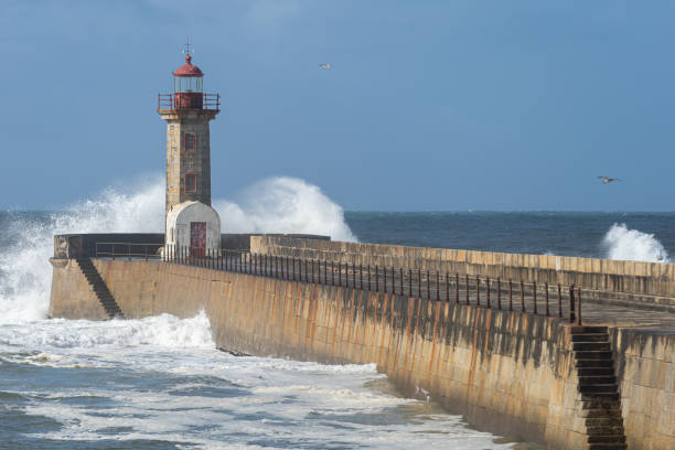 istock Waves hitting the lighthouse on a sunny day 1217218765